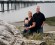 family at the river side on an overcast day